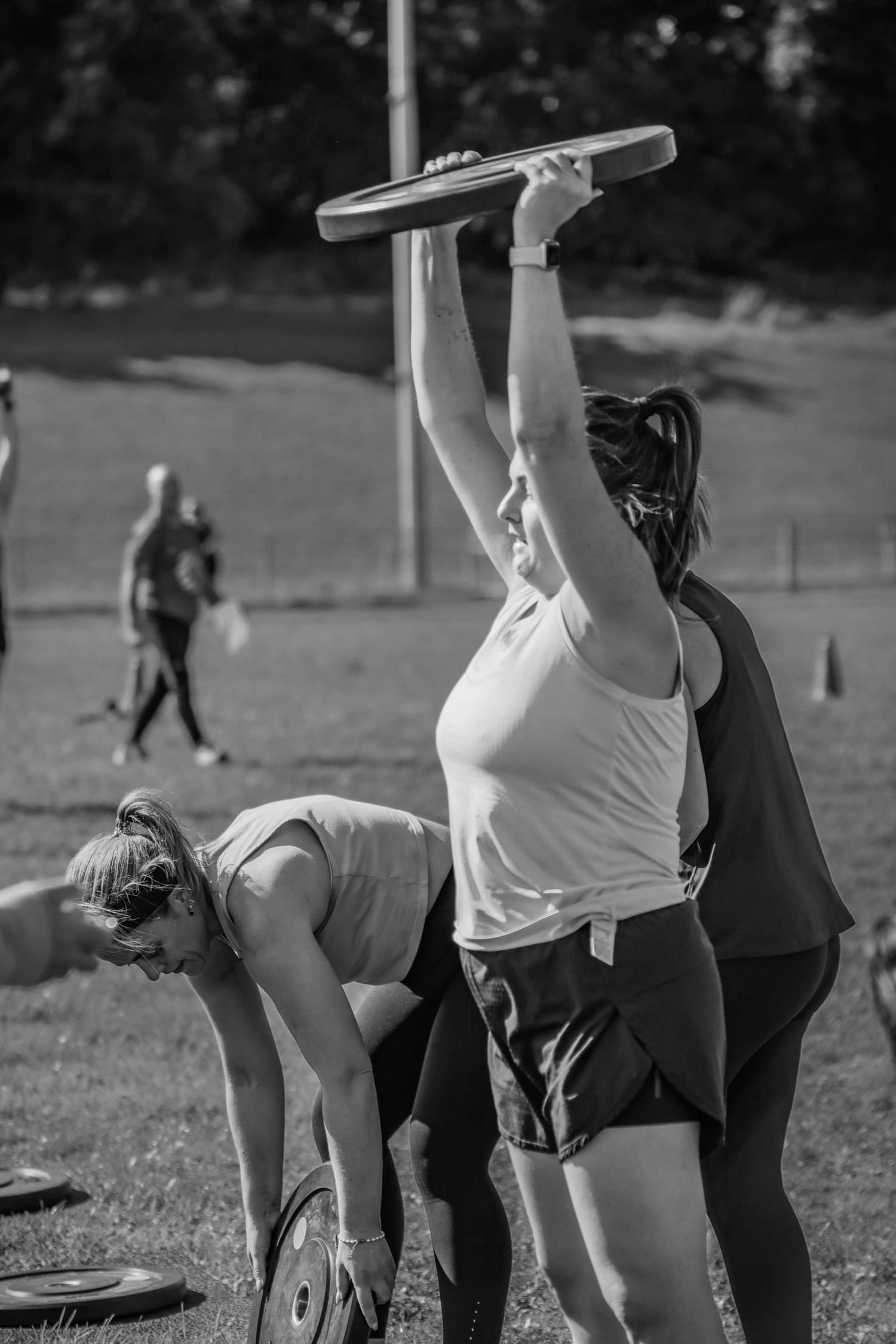 Atleet maak 'n gewigplaat skoon en druk in die Skoonmaak- en Persarbeid